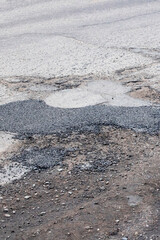 Holes in road are filled with stones