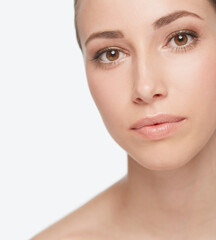 Obraz premium Portrait, beauty and skincare of woman in makeup, shine or glow isolated on white studio background. Face, serious and young model in cosmetics, dermatology and spa facial treatment for healthy skin