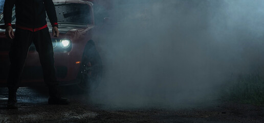 Muscle Car and a Driver Covered by Smoke After Heavy Burnout