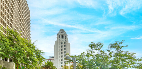 Los Angeles city hall under a blue sky with clouds