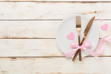 Festive table setting for Valentine's Day on wooden background, top view
