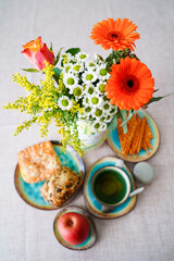 Breakfast with tea, cake and flowers