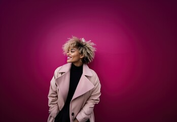 African American girl smiling in profile with blonde hair posing on pink background