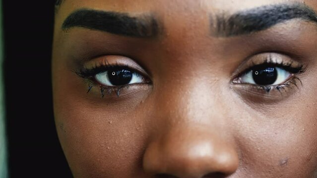 One young black latina adult girl macro close-up eyes detail staring at camera with intense gaze