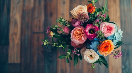 A bouquet of flowers sitting on top of a wooden floor