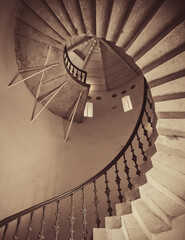 Sepia toned image of spiral staircase (view from below). Looking up at the stairwell  inside round...