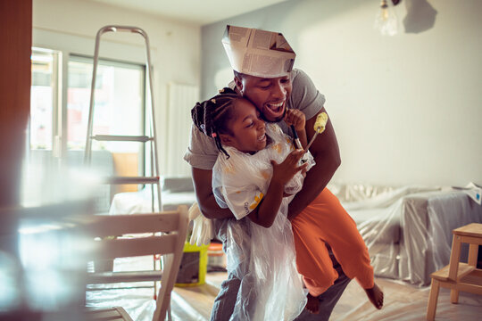 Father and daughter having fun while renovating at home