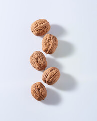 Walnuts with hard shadows in white