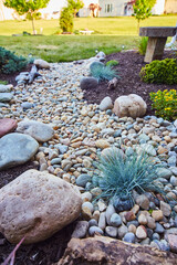 Tranquil Rock Garden with Ornamental Grass and Wooden Bench