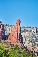 Sedona Red Rock Spire with Lush Greenery and Cliffs