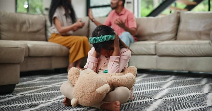 Divorce, fighting and girl on a floor with teddy bear for comfort from noise, shouting or toxic parents at home. Family, stress or kid in a living room with hands on ears, anxiety or fear of conflict