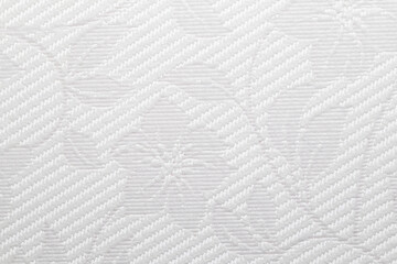 This image features a detailed close-up of a light gray textured vinyl wallpapers showcasing a...