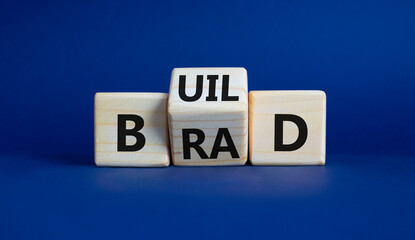 Build your brand symbol. Wooden cubes with words Build and Brand. Beautiful deep blue background. Build your brand and business concept. Copy space