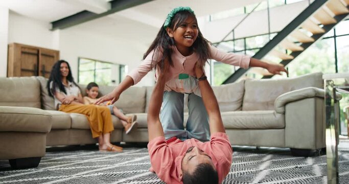 Father, daughter or airplane game on floor in home, weekend or play games to relax in apartment. Happy family, trust and fantasy flying with arms in air, freedom and bonding with care in living room