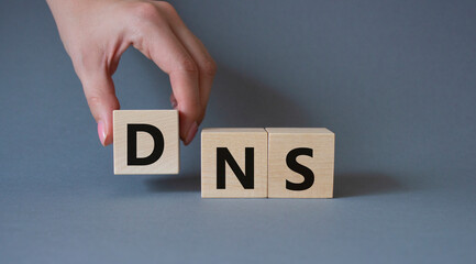 DNS -Domain Name Server - Consumer Price Index symbol. Concept word DNS on wooden cubes....