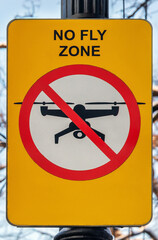 Street sign with inscription in English No fly zone prohibiting flights of drones