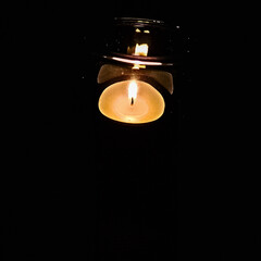 Candle in a candlestick in the dark