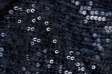 a large number of sequins on a black material