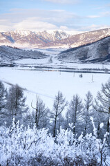 Cold snowy mountain landscape at sunset.