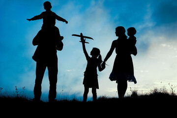 happy family by the sea on nature silhouette background