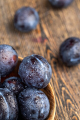 Wet purple plum on the table, fresh harvest