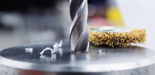 metal drill bit make holes in steel billet on industrial drilling machine - obrazy, fototapety, plakaty