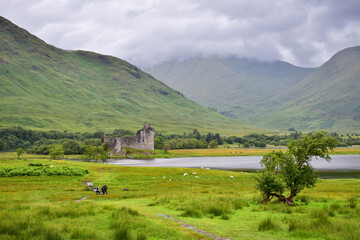 Kilchurn castle ruins by the loch lake on a cloudy day, Scotland