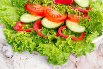Tasty fresh salad with vegetables on the desk
