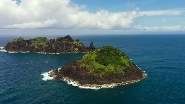 Top view of rocky tropical island in the blue ocean. Dos Hermanos Island. Santa Ana, Cagayan. Philippines.