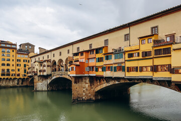 Obraz premium The Ponte Vecchio, a medieval stone closed-spandrel segmental arch bridge over the Arno, in Florence, Italy