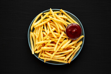 Homemade French Fries with Ketchup on a Plate, top view. Close-up.