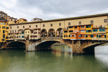 Fototapeta premium The Ponte Vecchio, a medieval stone closed-spandrel segmental arch bridge over the Arno, in Florence, Italy