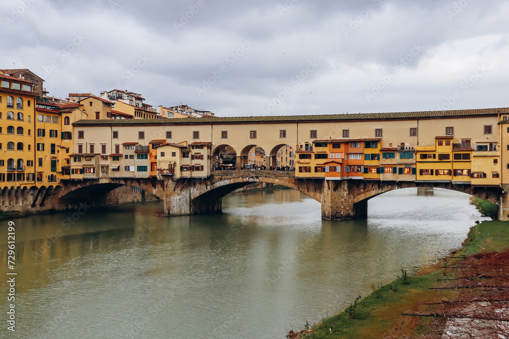 Wall mural the ponte vecchio, a medieval stone closed-spandrel segmental arch bridge over the arno, in florence