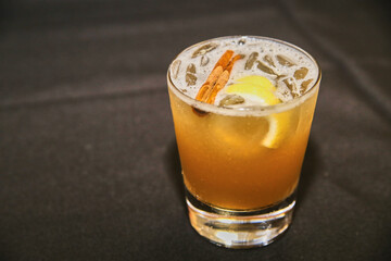 Craft Cocktail with Cinnamon and Lemon Garnish Close-Up