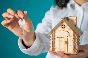 Keys to Home: Woman Holding Wooden Cabin, and keys
