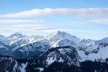 Panorama of a snow covered mountain lake. Winter mountain snow lake. Lake in snowy mountains. Mountain lake in snow