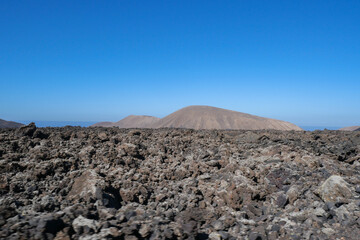 The volcanic mountain landscape of Lanzarote, Spain, under a clear sky