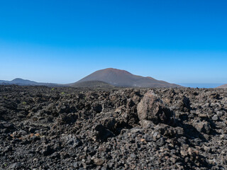 The volcanic mountain landscape of Lanzarote, Spain, under a clear sky