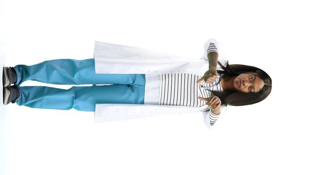 A female doctor, on a white background, in full height, shows her thumbs down