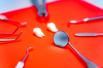 Dental instruments and tools on red background