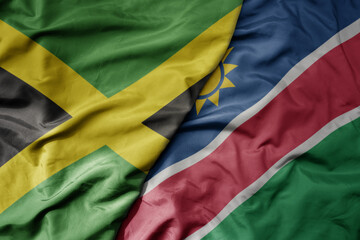 big waving national colorful flag of namibia and national flag of jamaica .