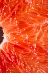 Macro photography of a grapefruit slice. Fresh fruit, pulp and peel detail