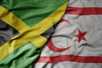 big waving national colorful flag of northern cyprus and national flag of jamaica .