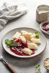 Lazy dumplings, vareniki with raspberry jam decorated with almond petals and mint leaves. Boiled cottage cheese homemade gnocchi