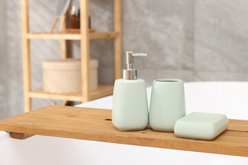 Fototapeta na wymiar Set of bath accessories on tub in bathroom