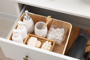 Fototapeta na wymiar Different bath accessories and personal care products in drawer indoors, above view