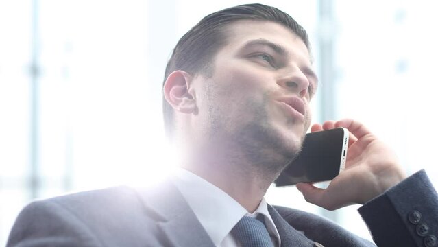 A male businessman is talking on the phone and negotiating a deal