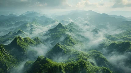 Foto op Plexiglas  an aerial view of a mountain range covered in clouds and green vegetation in the foreground, with mountains in the distance, and a cloudy sky in the background. © Anna