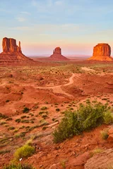Fotobehang Baksteen Golden Hour at Monument Valley with Sandstone Buttes and Desert Road  © Nicholas J. Klein