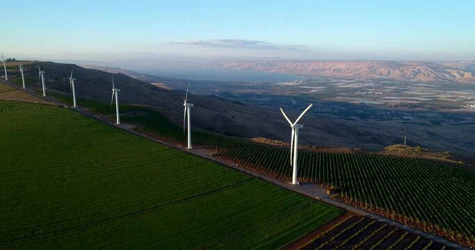 Aerial footage of a wind turbine in the mountains above the Sea of Galilee.
